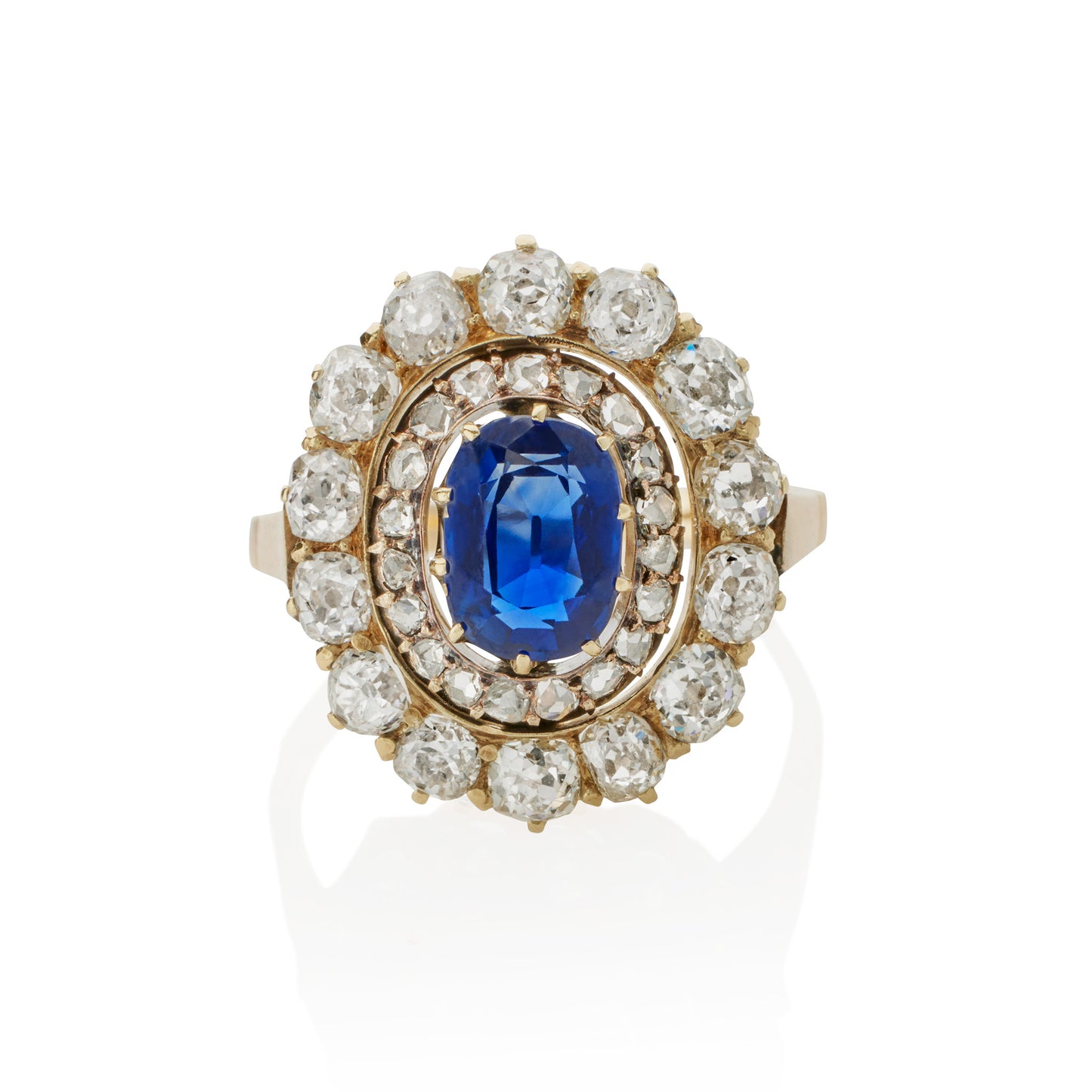 Macklowe Gallery An English Antique 15 karat gold/silver top ring with sapphire and diamonds. The ring centers on a no heat oval-cut sapphire with an approximate weight of .95 carat, 14 old mine-cut diamonds with an approximate total weight of 1.40 carats, and 19 rose-cut diamonds with an approximate total weight of .19 carat.  Designed in a classic oval cluster motif.
